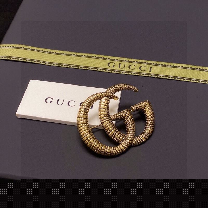G*u*i brooches